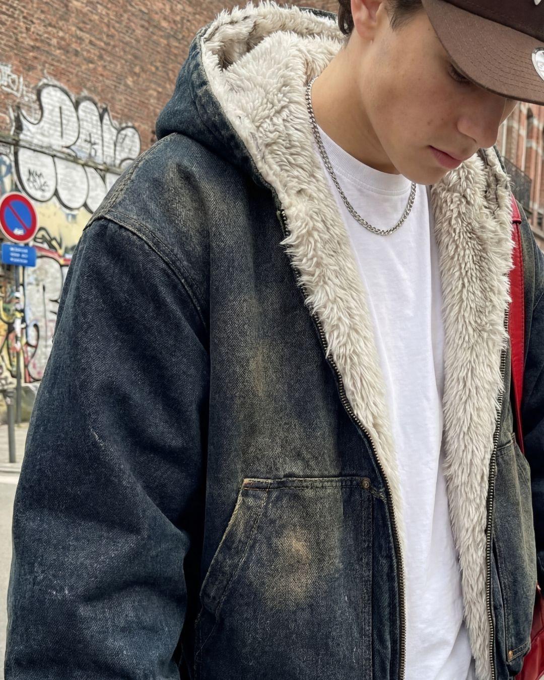 Hooded denim jacket with plush faux fur lined hood — close-up on model
