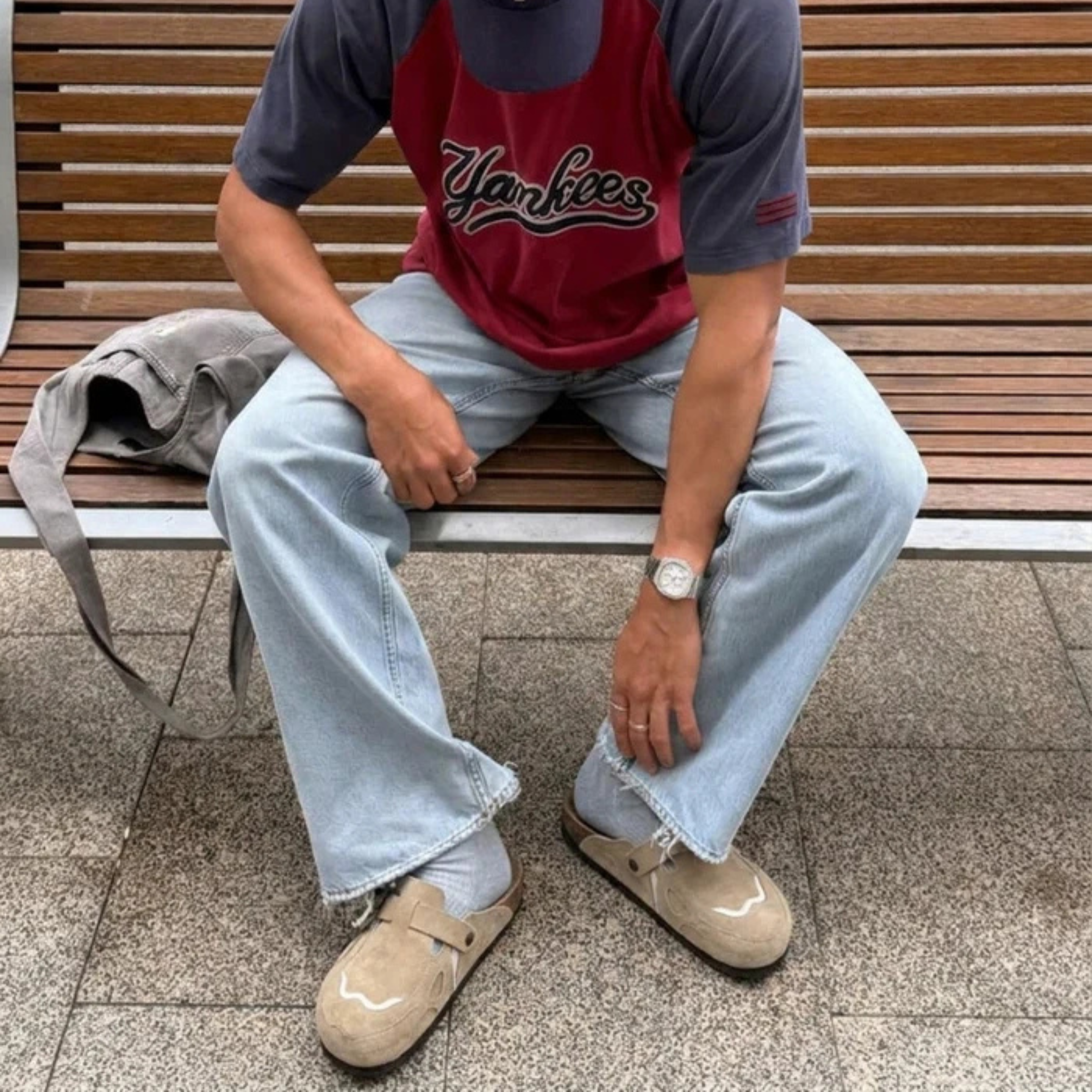 Model wearing Wavey Clogs in beige with light wash jeans