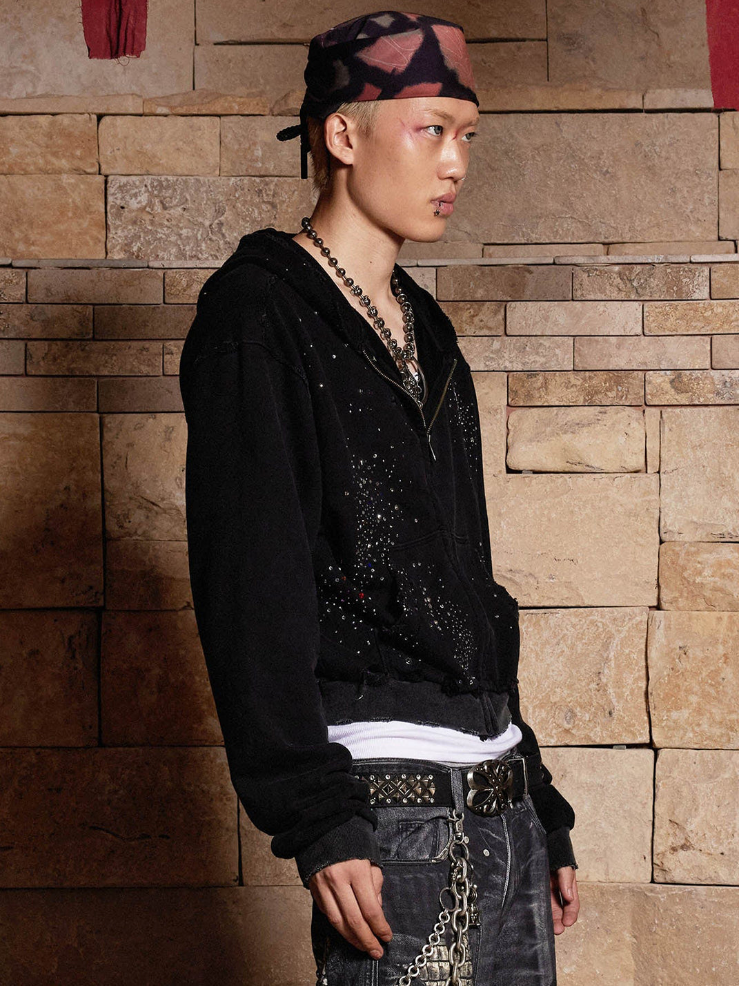 Black studded zip hoodie side profile — layered streetwear look