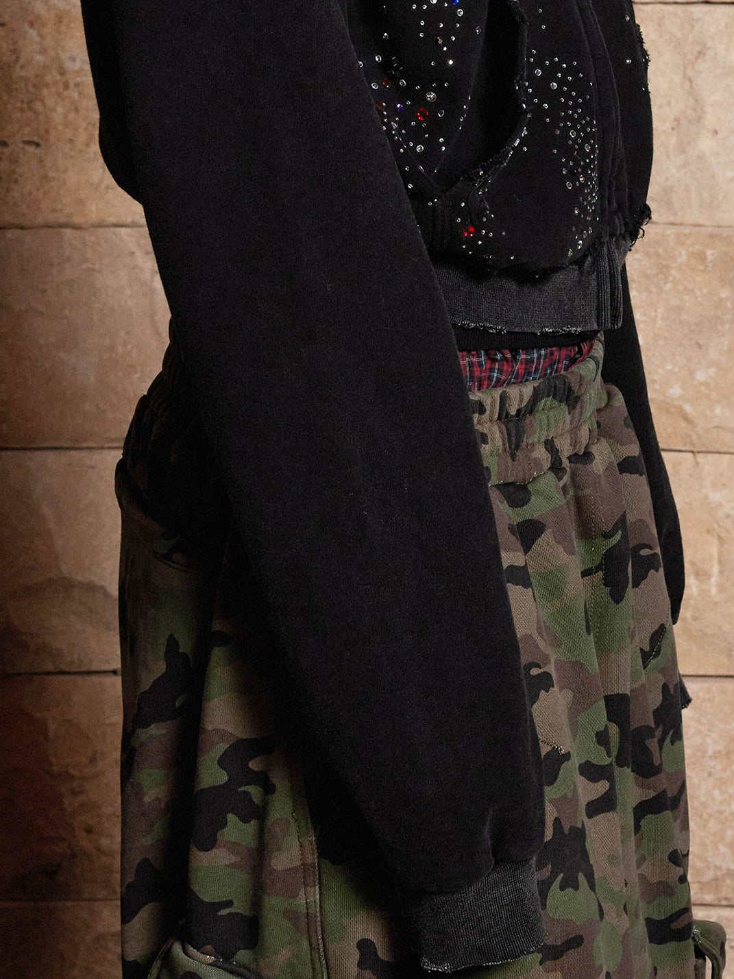 Washed black hoodie sleeve and back detail with camo pants