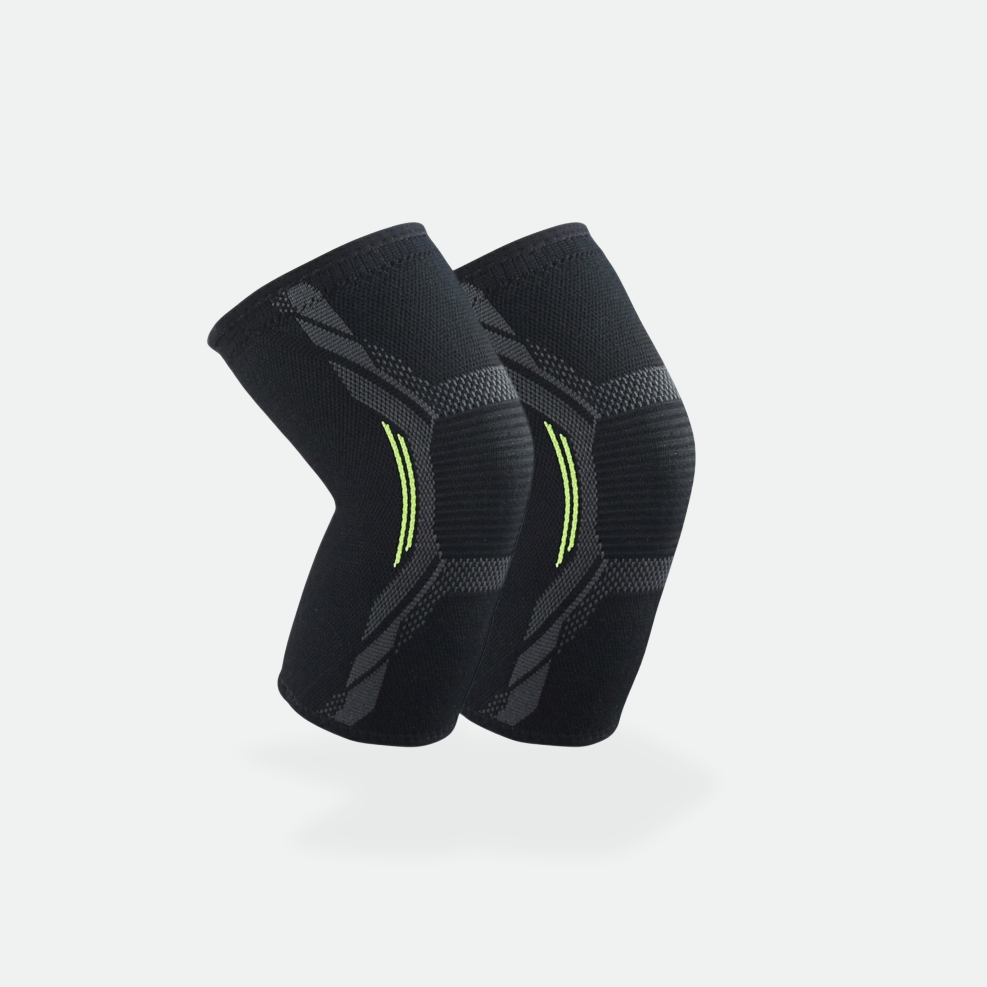 Pair of black knee sleeves with green accents on a light gray background