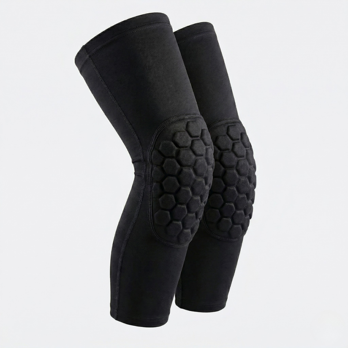 Pair of black knee pads with honeycomb pattern on a light gray background
