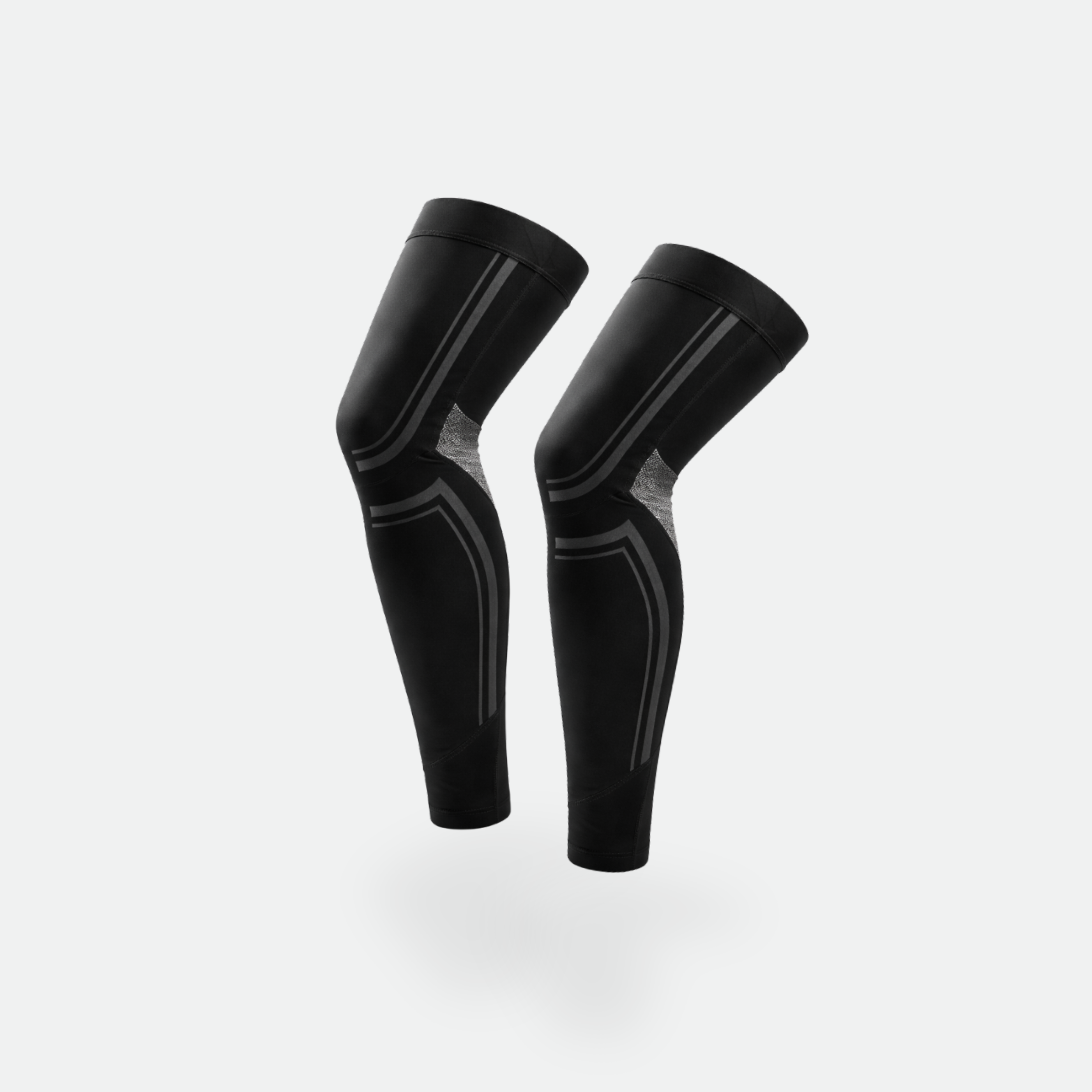 Pair of black compression leg sleeves on a light gray background
